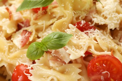 Photo of Delicious pasta with tomatoes, basil and parmesan cheese as background, closeup