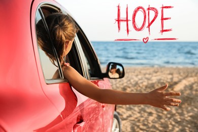 Image of Concept of hope. Little girl leaning out of car window on beach
