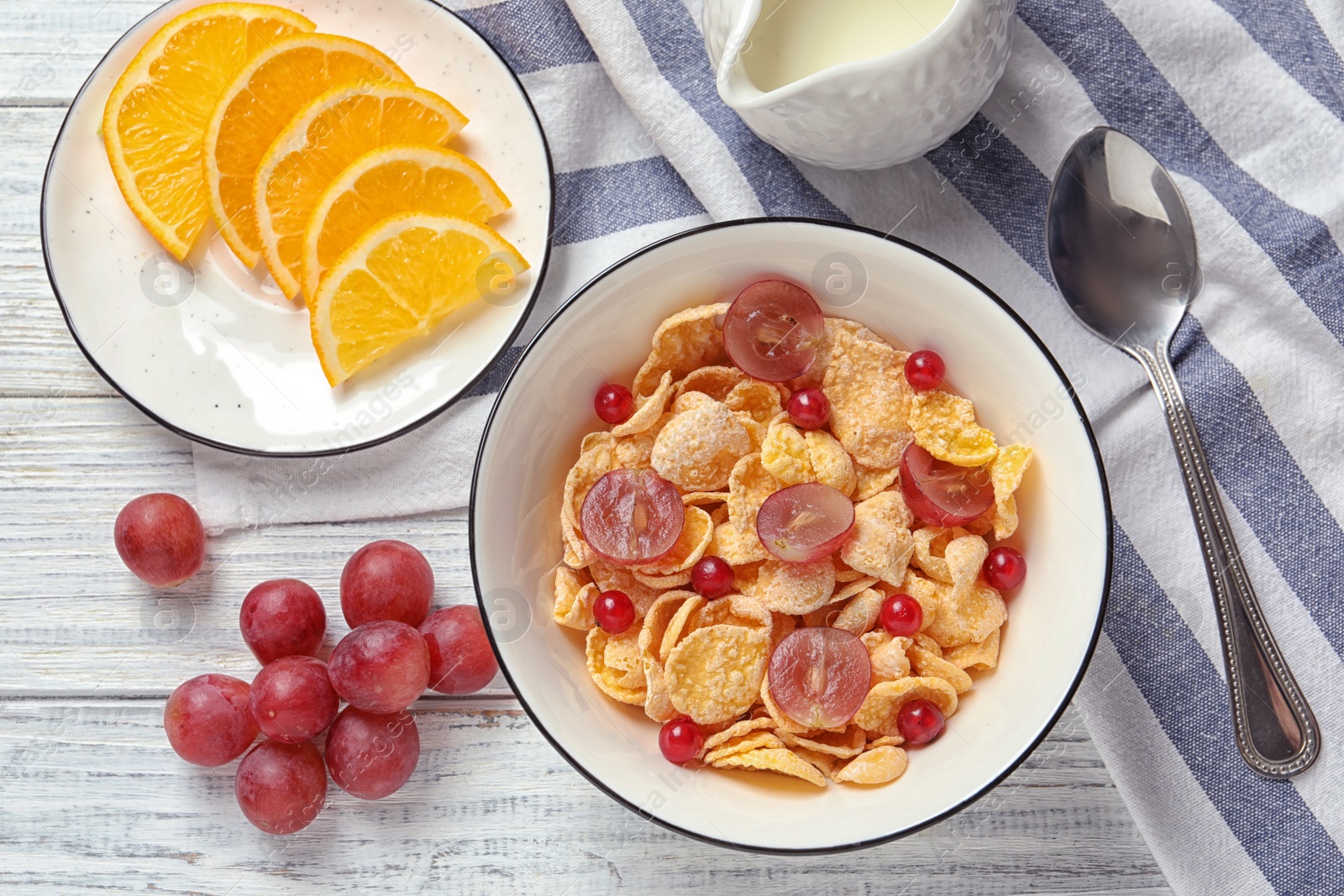 Photo of Tasty healthy breakfast served on white wooden table, flat lay