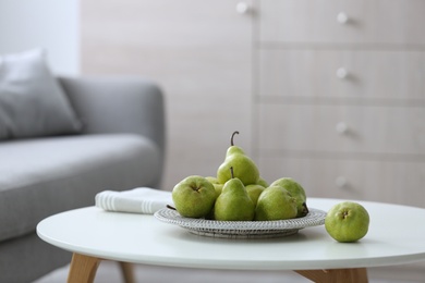 Photo of Fresh ripe pears on white table in room