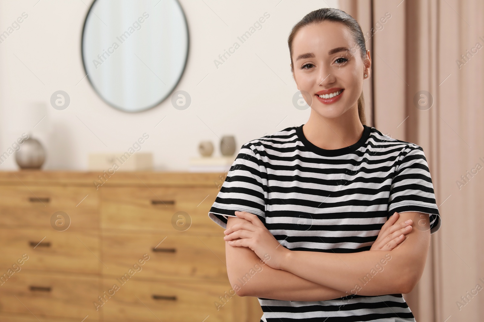 Photo of Portrait of beautiful young woman indoors, space for text. Attractive lady smiling and looking into camera