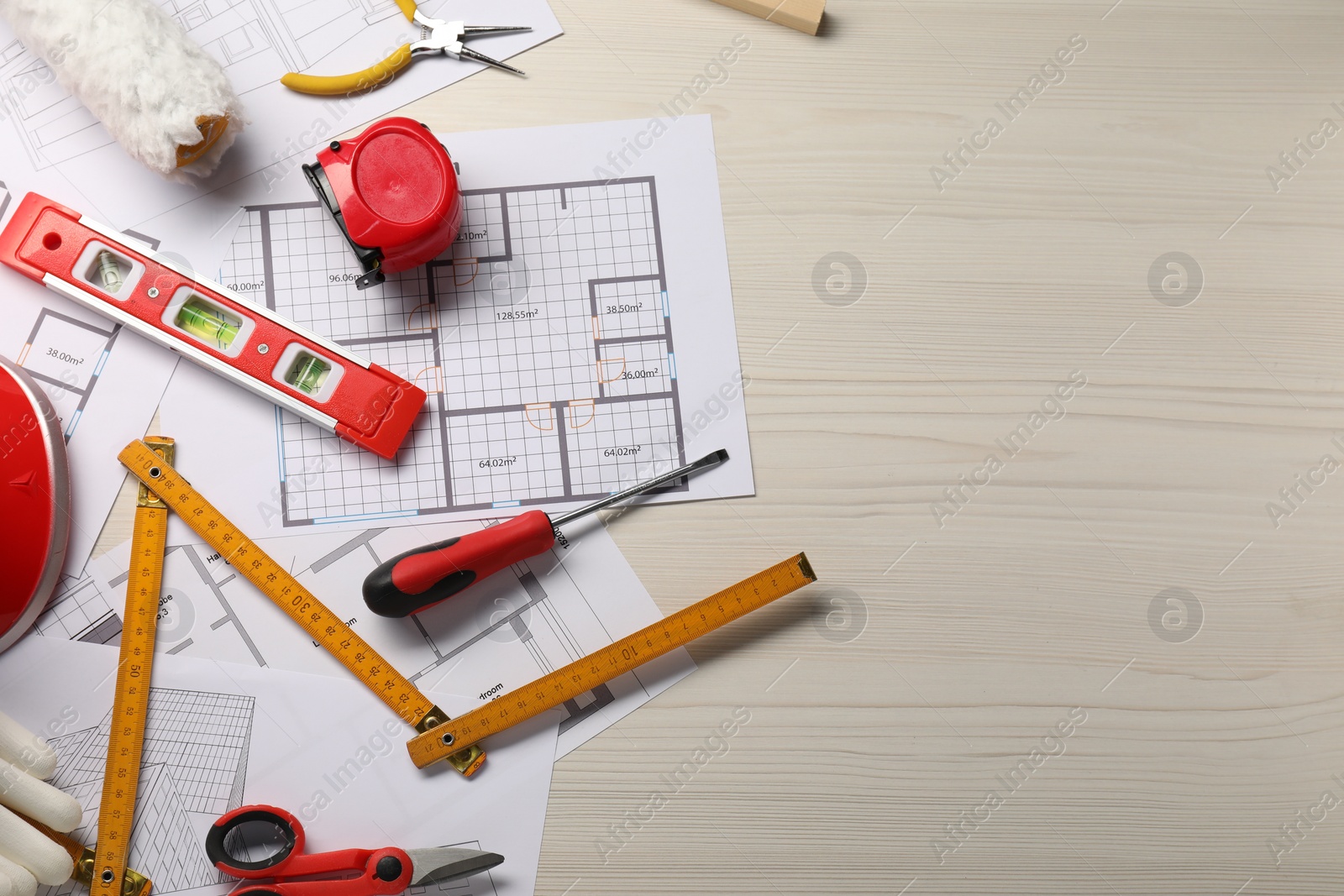 Photo of Flat lay composition with building level and other construction tools on white wooden table, space for text