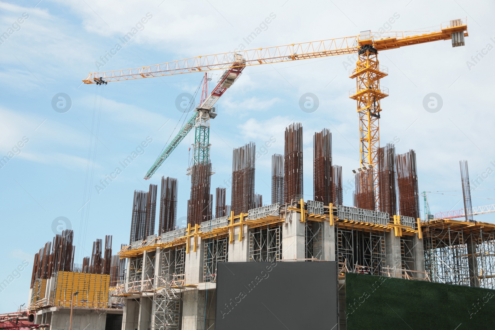 Photo of View of construction site with modern tower cranes