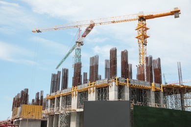 Photo of View of construction site with modern tower cranes