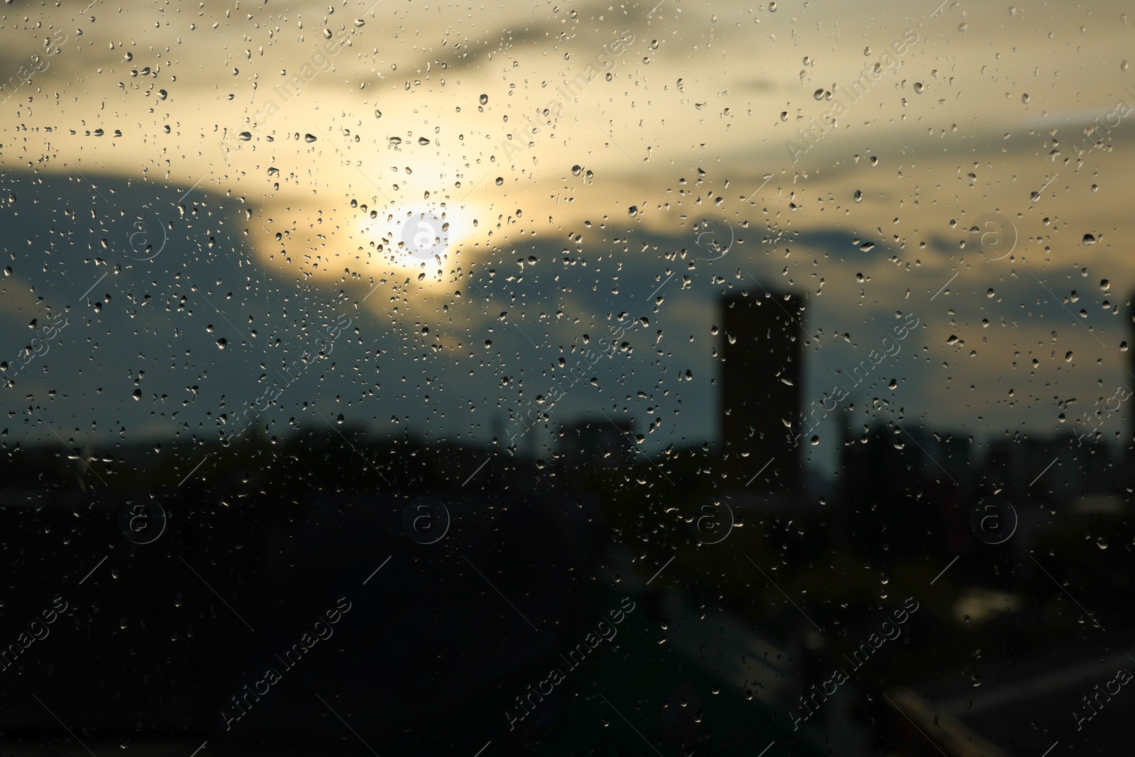 Photo of Window glass with droplets on rainy day, closeup