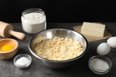 Making shortcrust pastry. Different ingredients for dough and rolling pin on grey table