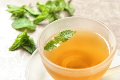 Photo of Cup with hot aromatic mint tea, closeup