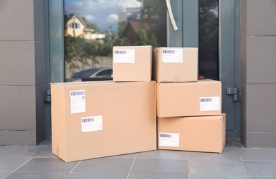 Photo of Stack of parcel boxes on floor near entrance