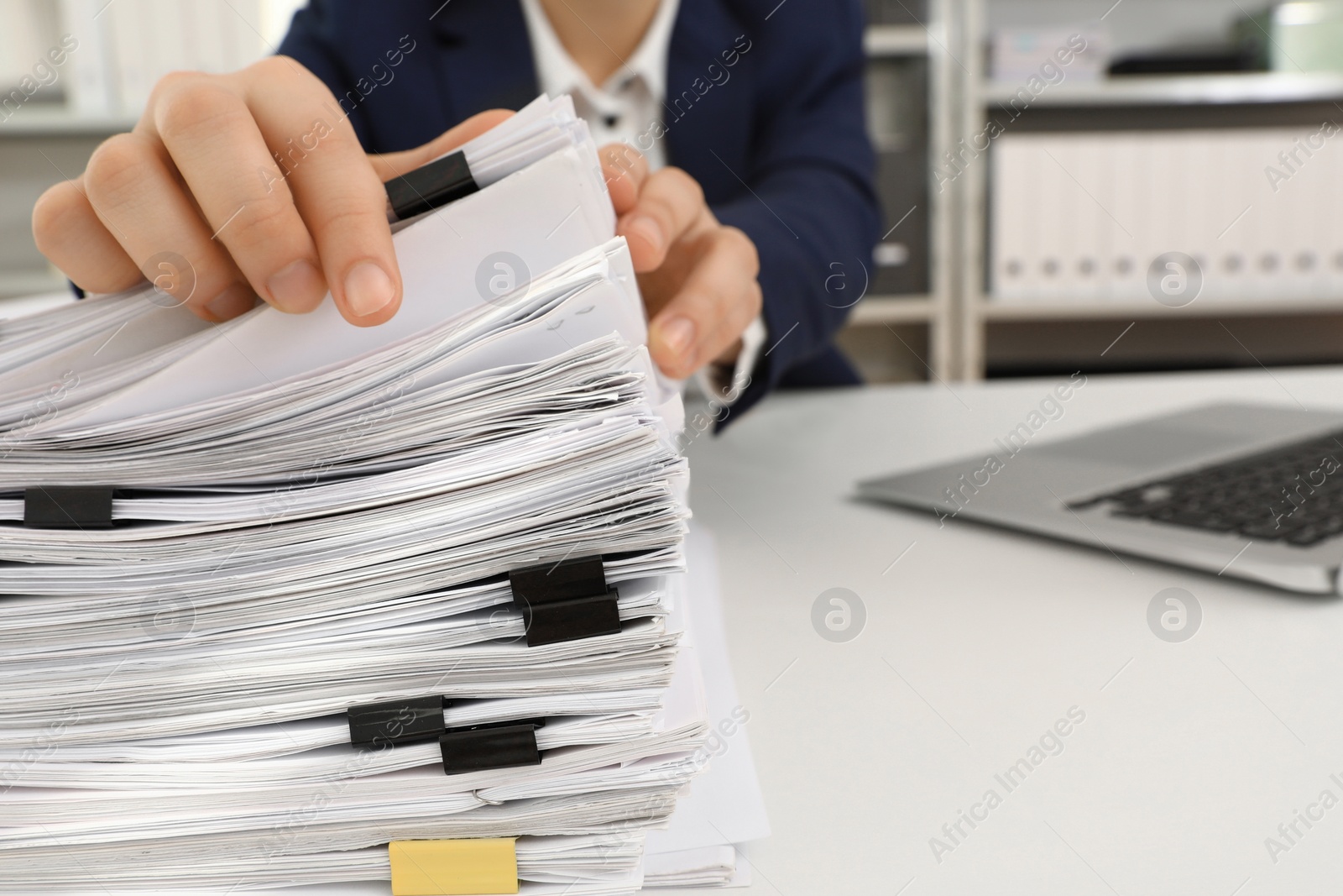 Photo of Woman working with documents at table in office, closeup. Space for text