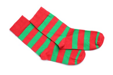 Pair of striped socks on white background, top view