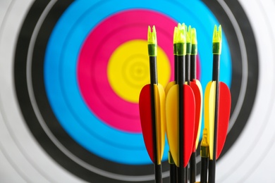 Many arrows against archery target, closeup view. Space for text