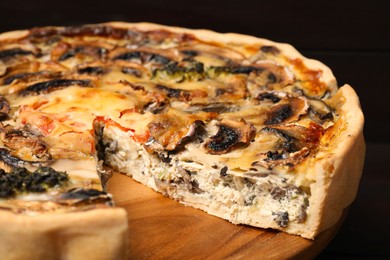 Photo of Delicious quiche with mushrooms on wooden table, closeup