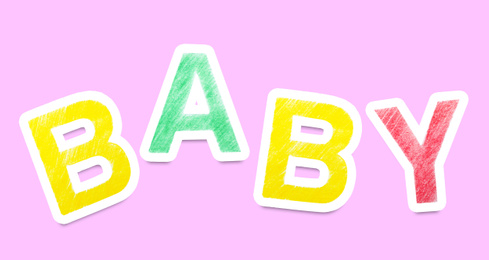 Image of Word BABY made of paper letters on pink background. Banner design