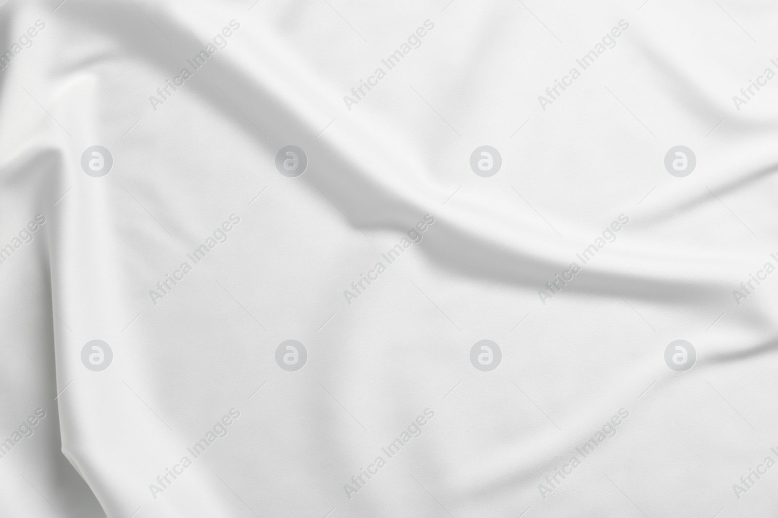 Photo of Texture of white silk ripple fabric as background, top view