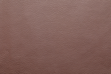 Photo of Texture of brown leather as background, closeup