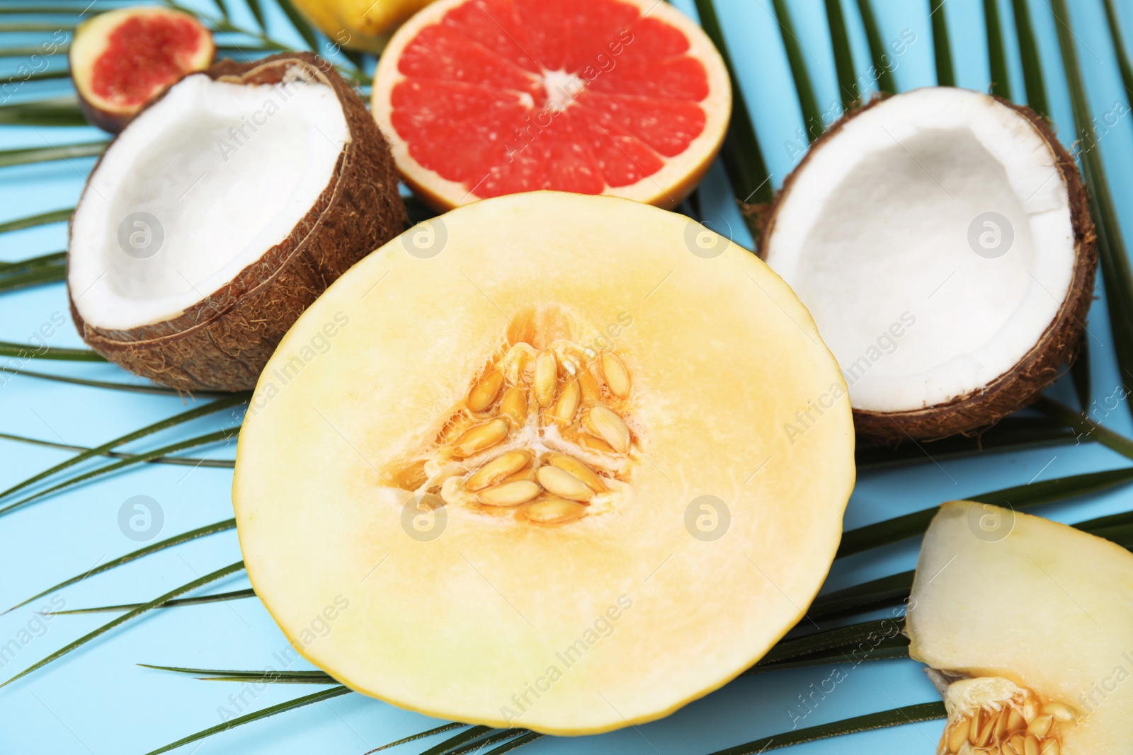 Photo of Juicy melon and other fruits on color background