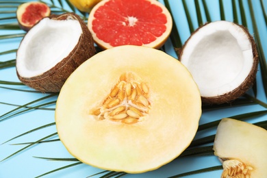 Photo of Juicy melon and other fruits on color background