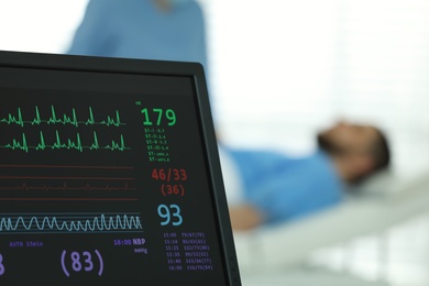 Monitor with cardiogram in hospital, focus on screen. Space for text