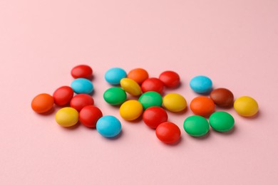 Photo of Tasty colorful and sweet candies on pink background