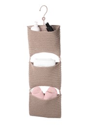 Stylish knitted organizer with toiletries, towel and slippers on white background. Bath accessory