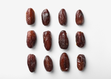 Photo of Sweet dates on white background, top view. Dried fruit as healthy snack