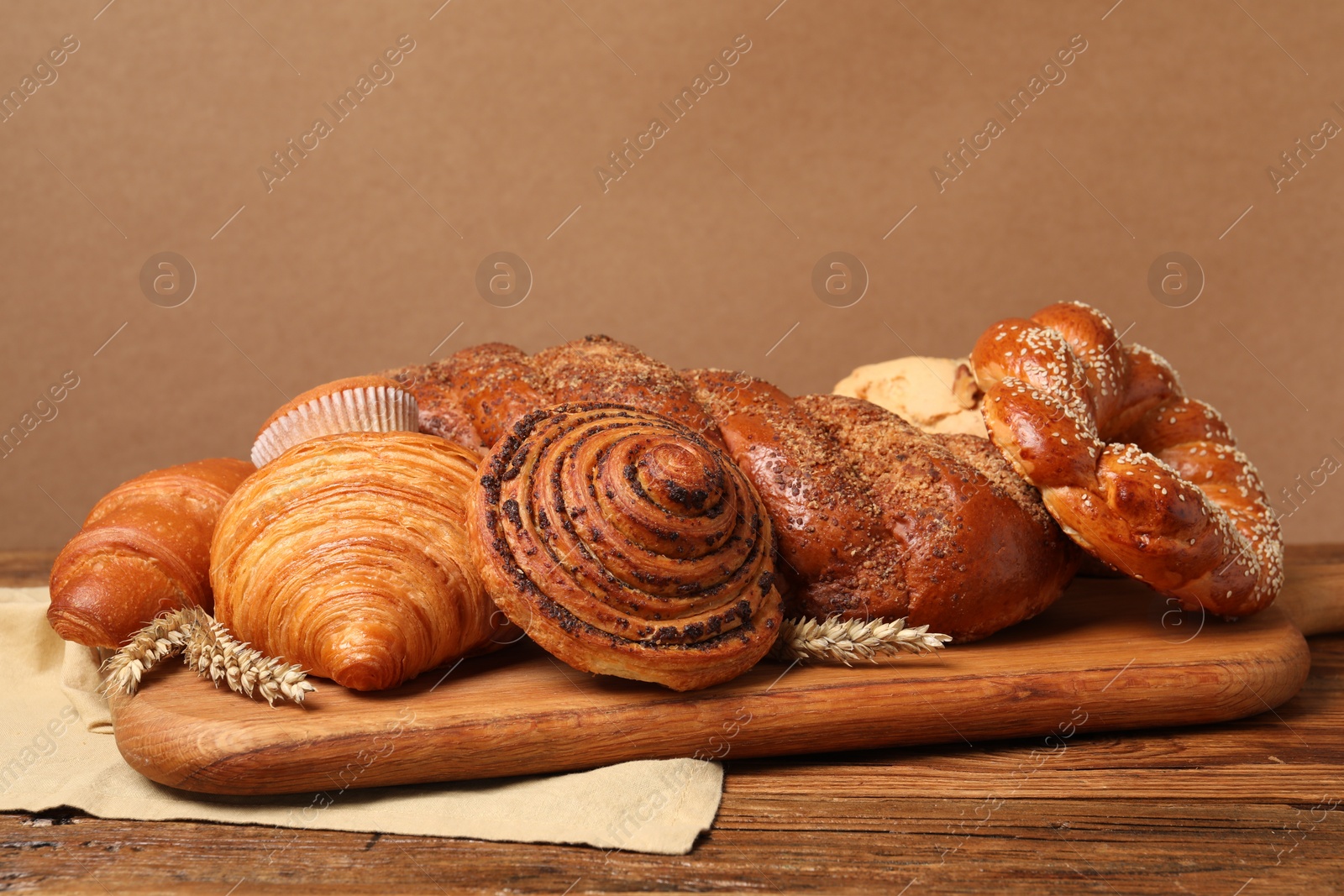 Photo of Different tasty freshly baked pastries on wooden table