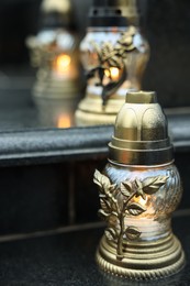 Photo of Grave lights on granite surface at cemetery