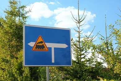 Photo of Traffic sign Railroad Level Crossing Without Barriers outdoors on sunny day, space for text