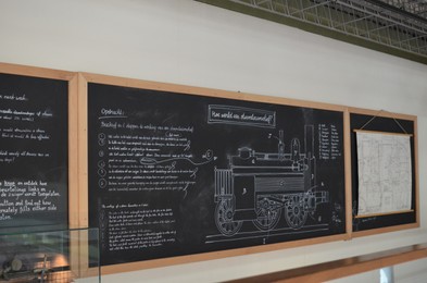Photo of Utrecht, Netherlands - July 23, 2022: Blackboard with drawing of historical steam train in Spoorwegmuseum