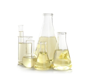 Laboratory glassware with liquid on white background. Chemical analysis