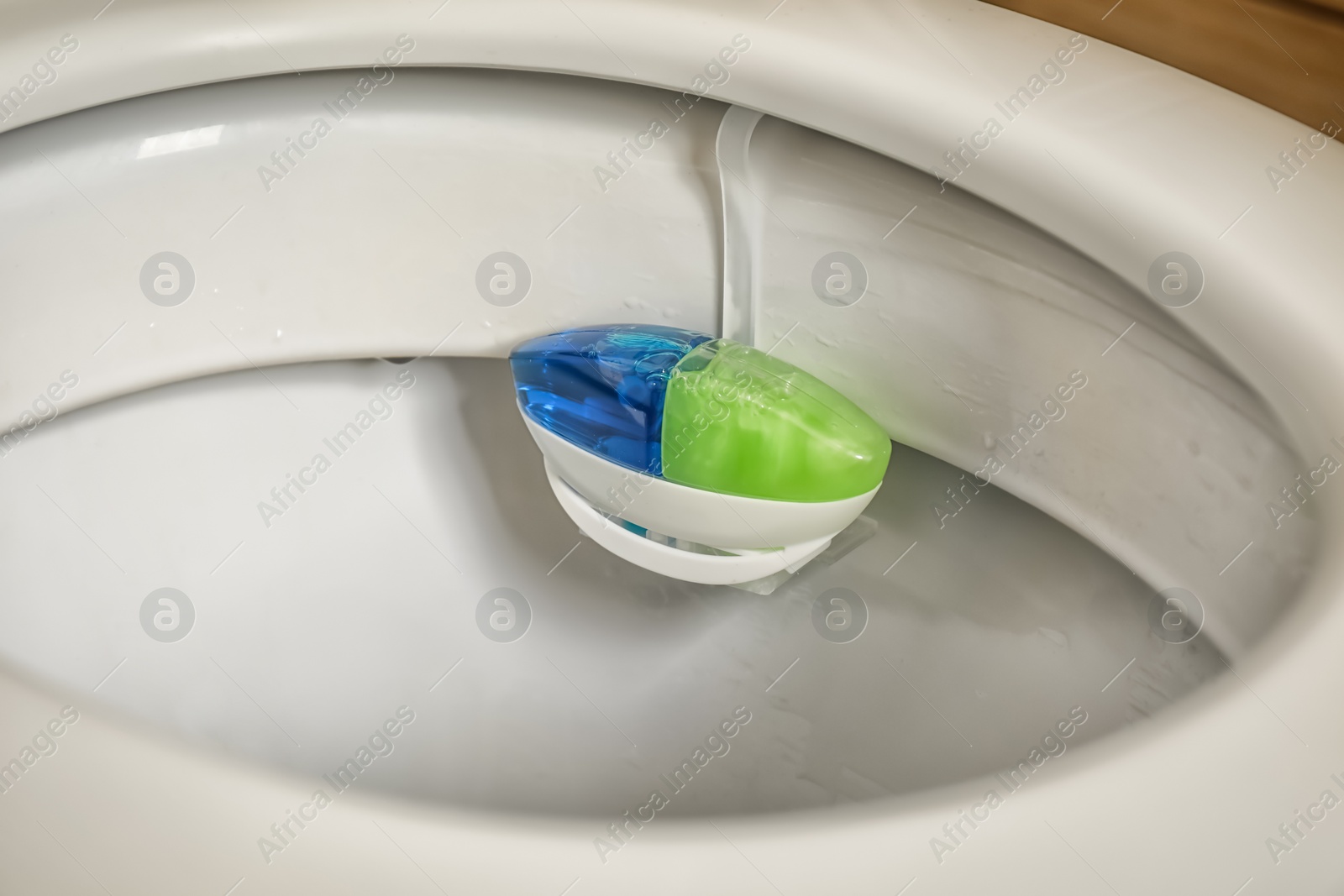 Photo of Toilet with rim block, closeup. Air freshener