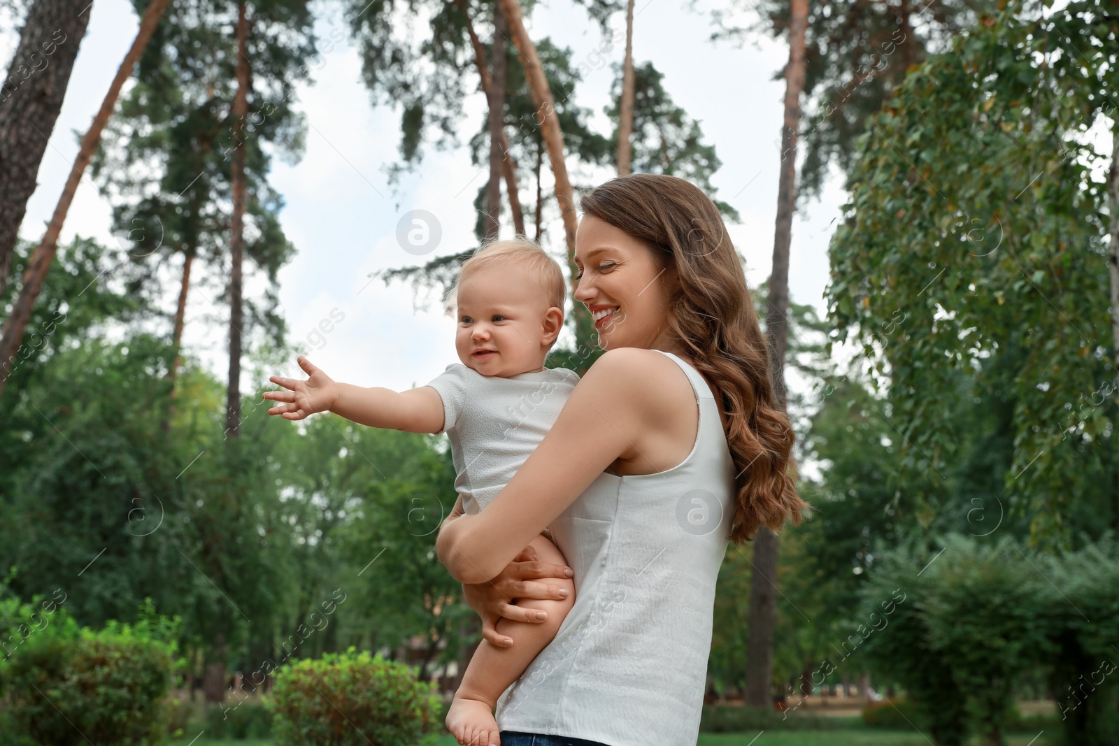 Photo of Mother with her cute baby spending time together outdoors