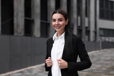 Photo of Portrait of smiling woman outdoors. Lawyer, businesswoman, accountant or manager