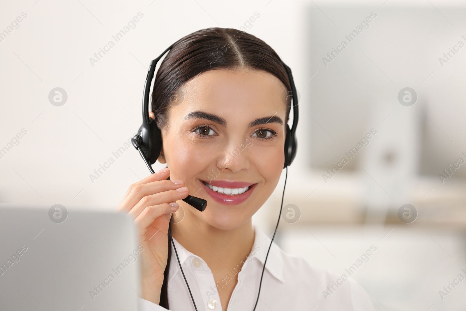 Photo of Hotline operator with headset working in office