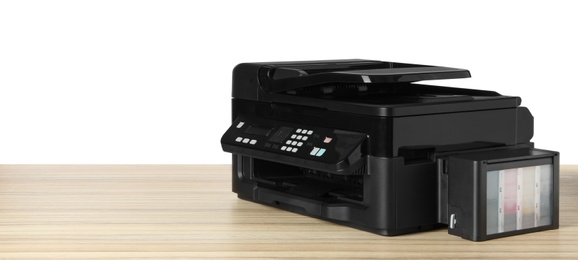 New modern multifunction printer on wooden table