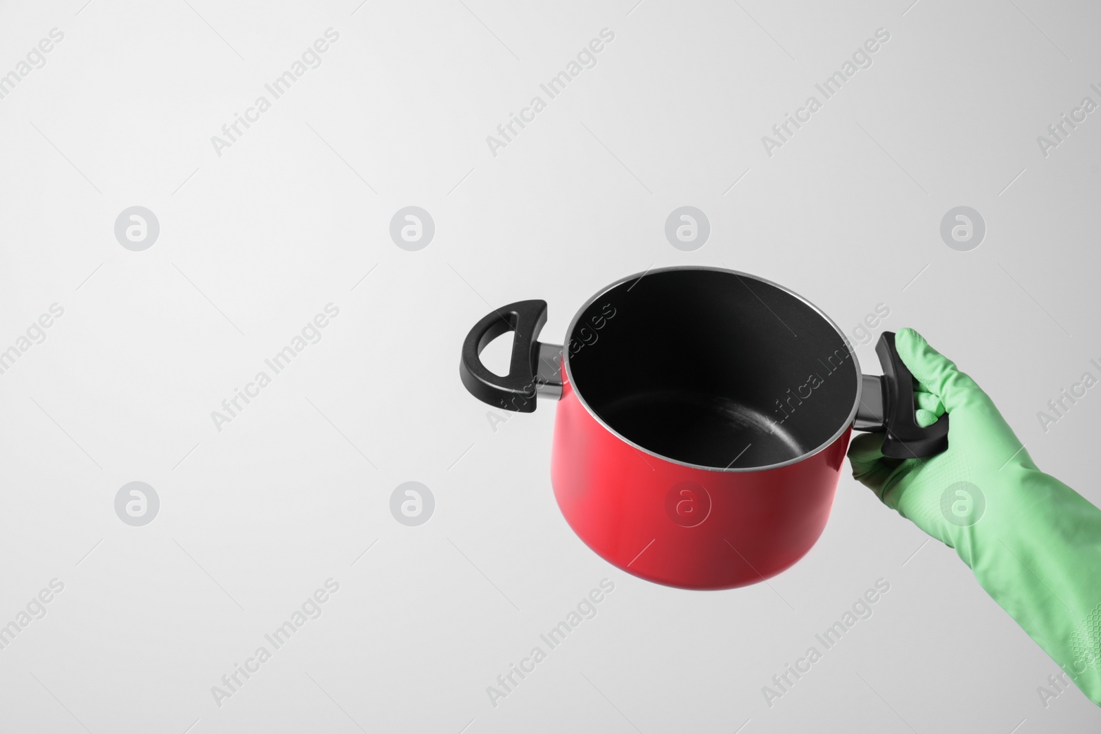Photo of Woman holding empty pot on white background, closeup. Space for text