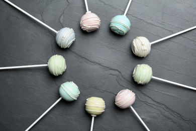 Sweet cake pops on grey background, flat lay. Space for text