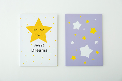 Photo of Adorable pictures of stars with words SWEET DREAMS on white wall. Children's room interior elements