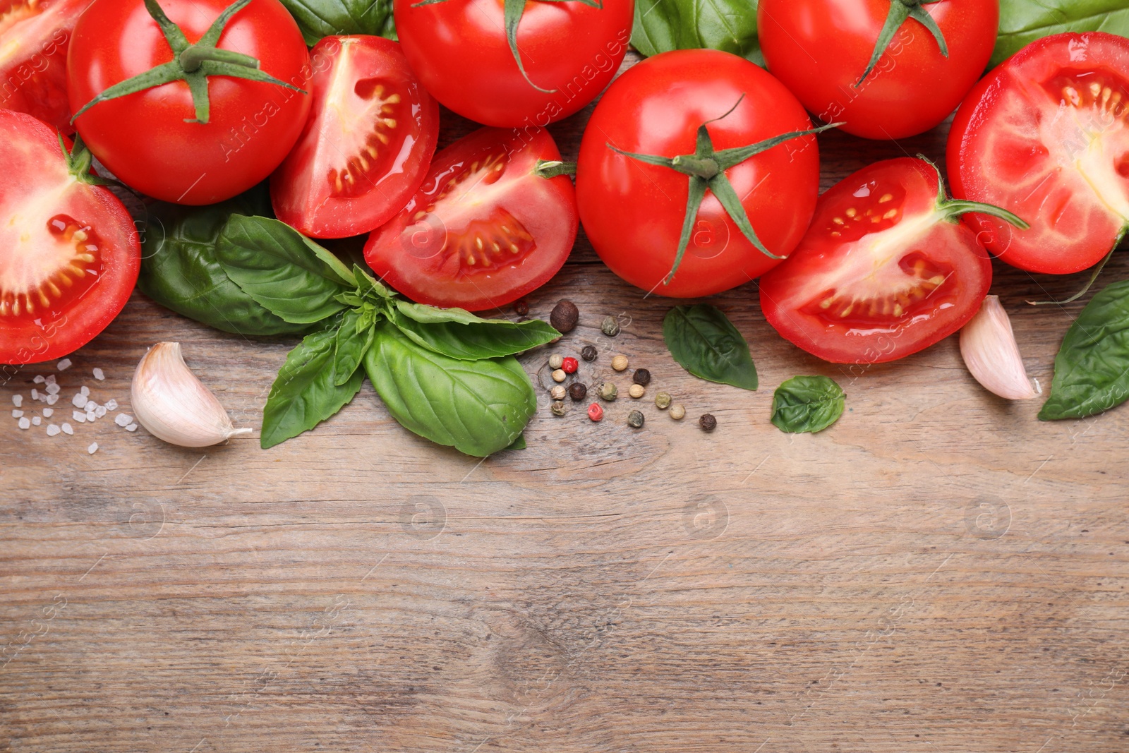 Photo of Flat lay composition with fresh green basil leaves on wooden table, space for text