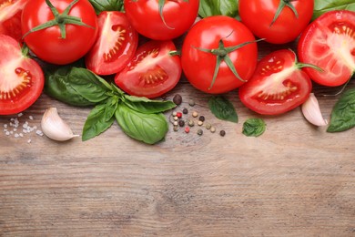 Photo of Flat lay composition with fresh green basil leaves on wooden table, space for text