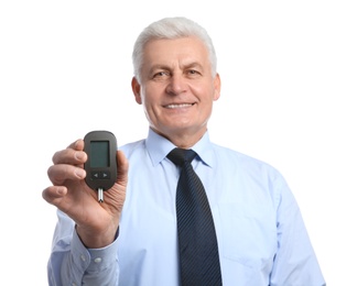 Photo of Senior man holding glucometer on white background. Diabetes control