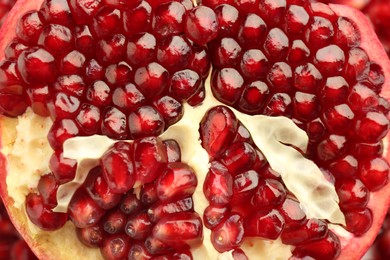 Photo of Ripe juicy pomegranate grains as background, closeup