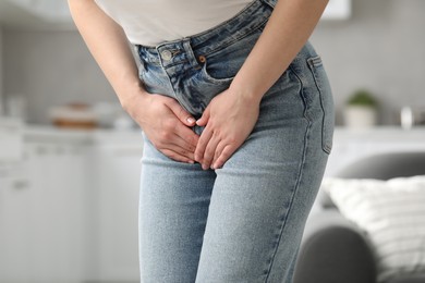 Photo of Woman suffering from cystitis at home, closeup