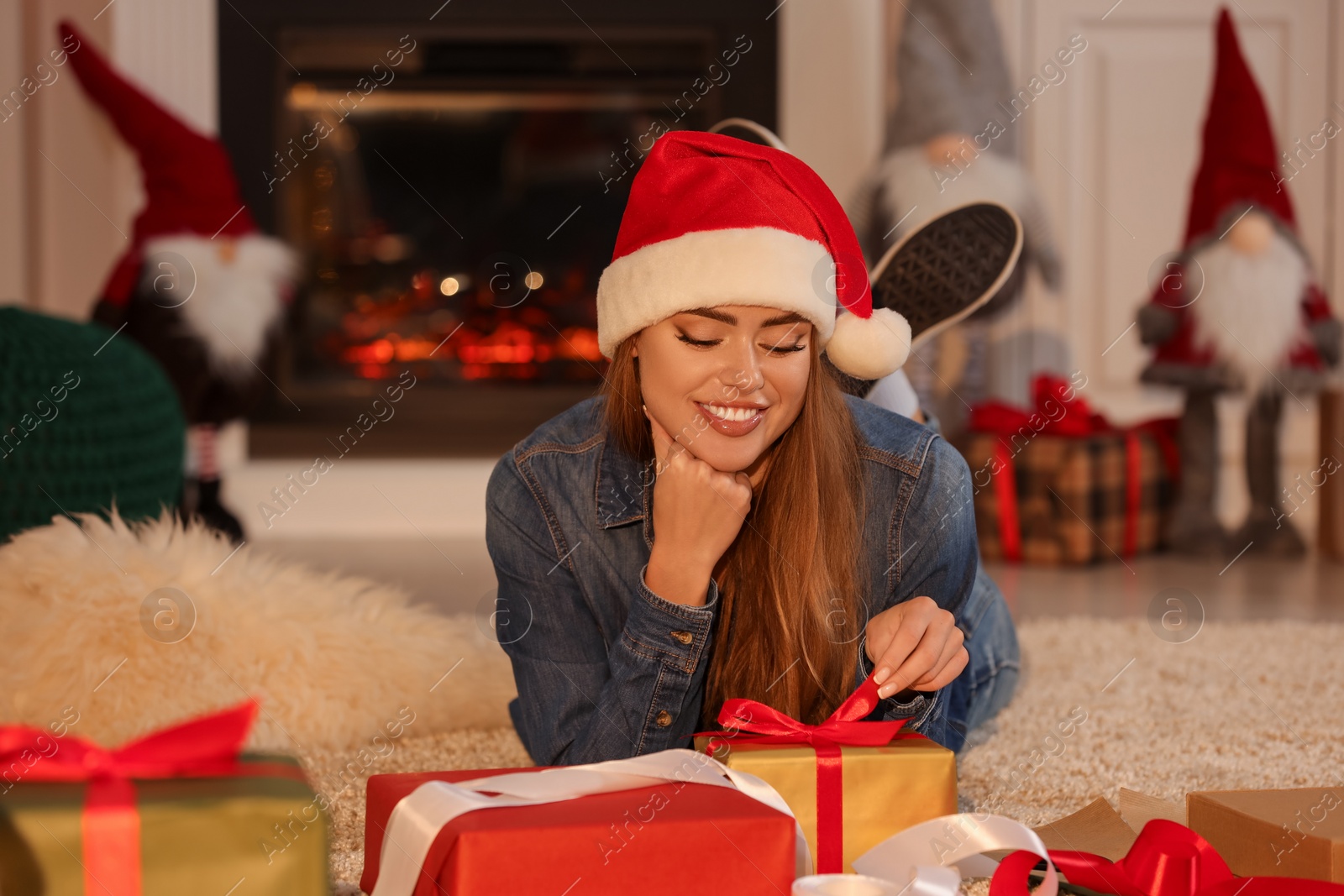 Photo of Beautiful young woman with Christmas gifts at home