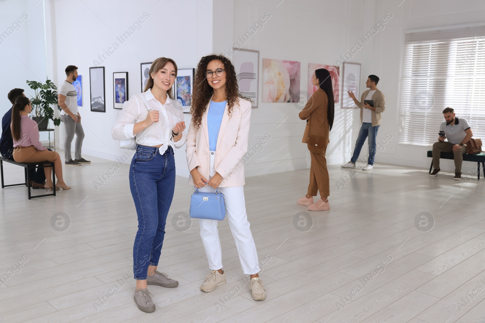 Photo of Young women at exhibition in art gallery