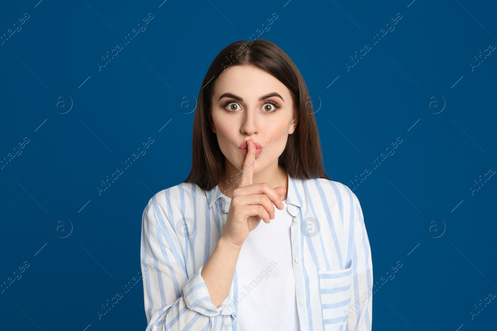 Photo of Portrait of young woman on blue background