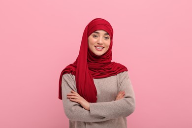 Portrait of Muslim woman in hijab on pink background