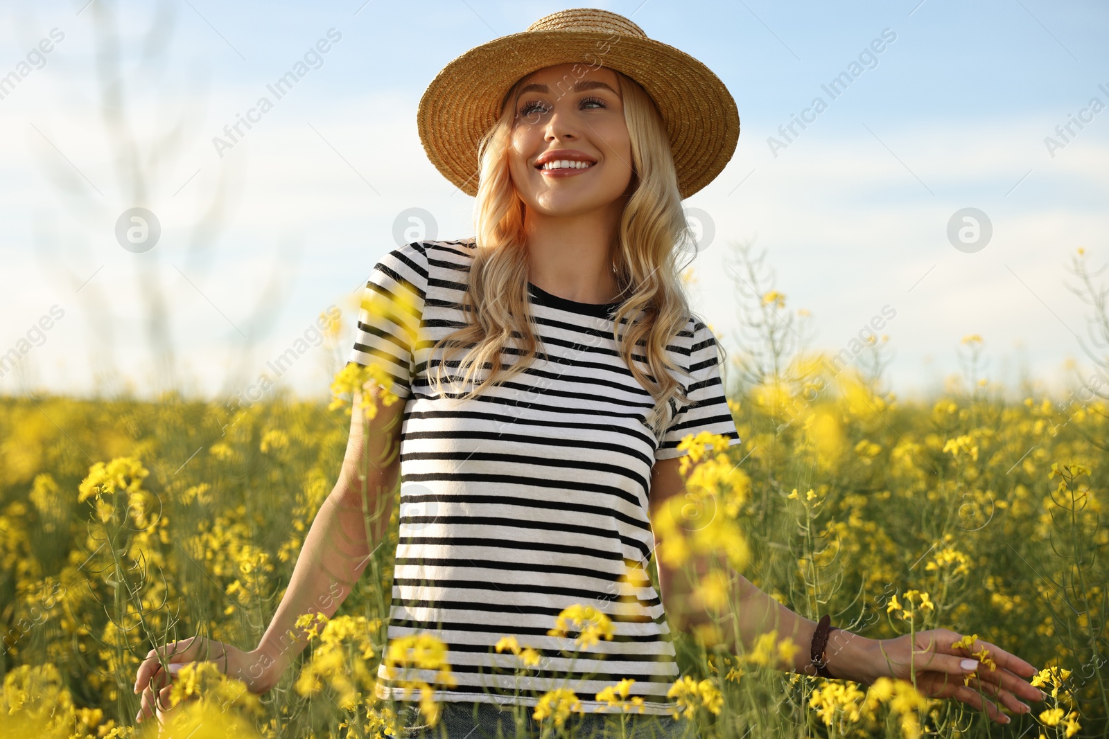 Photo of Happy young woman with straw hat in field on spring day