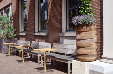 Photo of Beautiful view of outdoor cafe with stylish furniture on sunny day