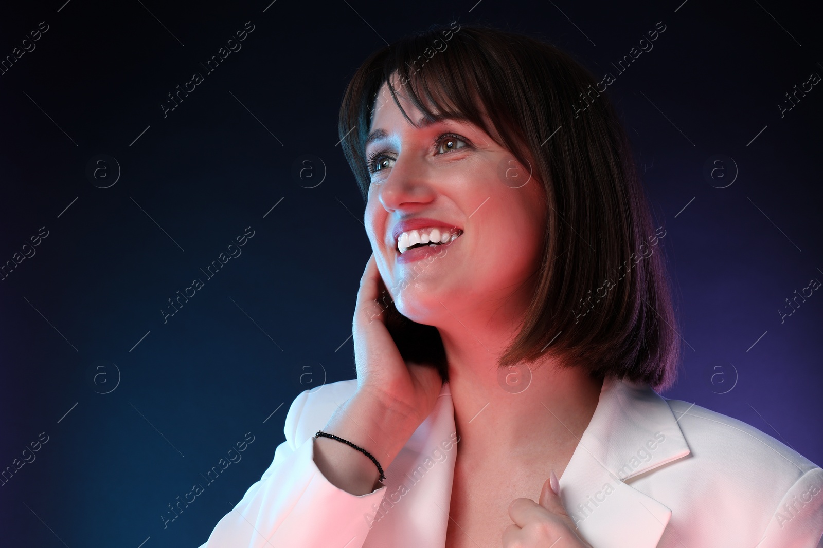 Photo of Portrait of happy woman on dark background, space for text